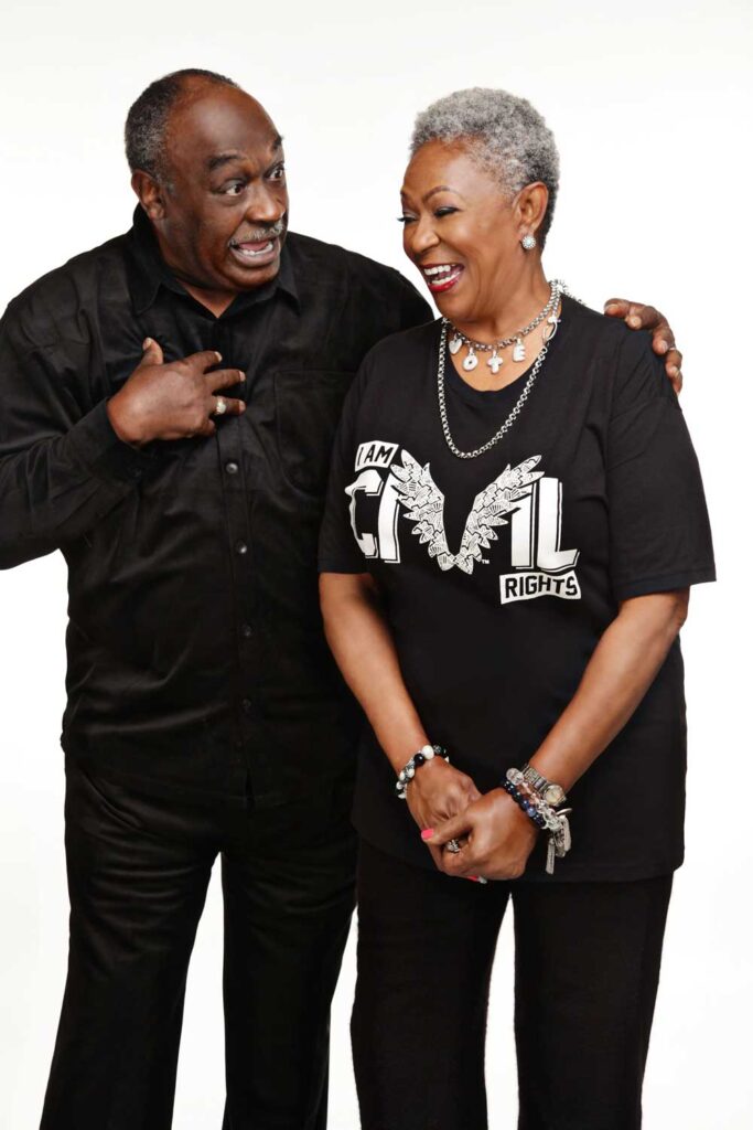 Paulette and Curtis Roby, laughing together, dressed in black.