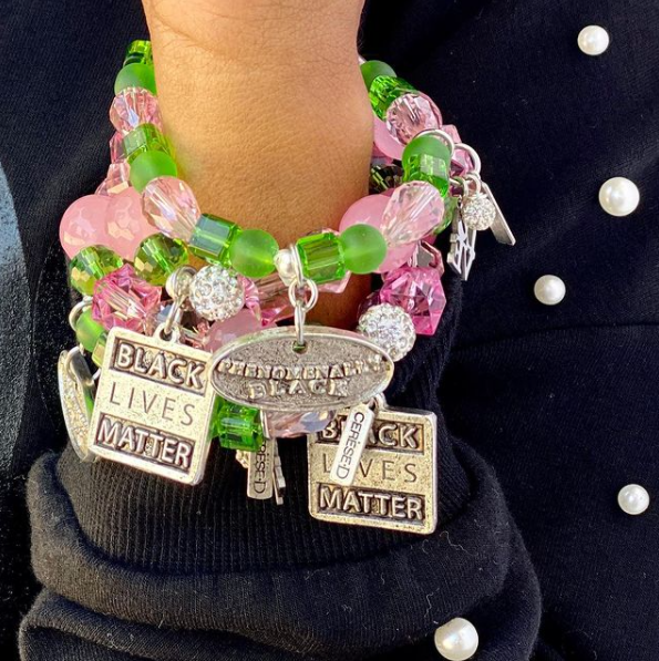 Black excellence charm bracelet with pink and green beads