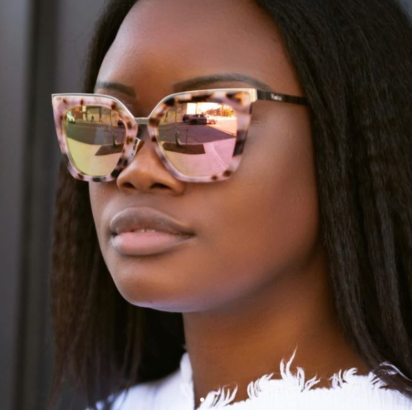 black woman wearing pink tortoise framed sunglasses