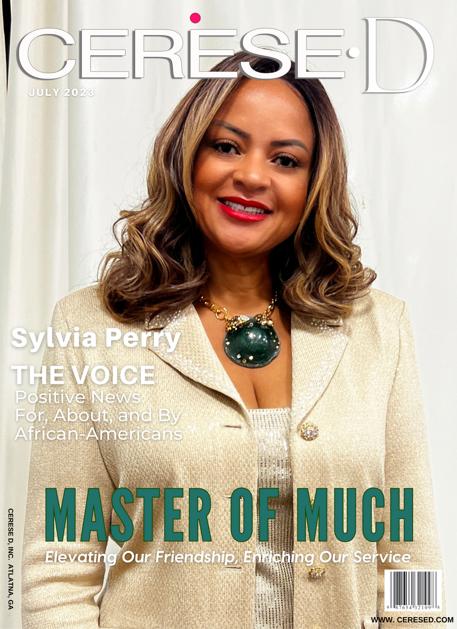 Image of beautiful black woman smiling in front of a white draped background wearing a cream colored suit jacket and a large green stone pendant with gold chain on a Cerese D magazine cover