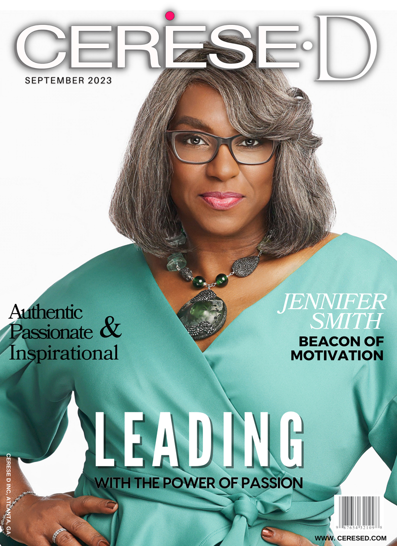image of a strong black woman wearing a sea foam colored top staring directly at the camera and wearing black rimmed eyeglasses and a large green stone and blackened silver beaded necklace on a Cerese D magazine cover